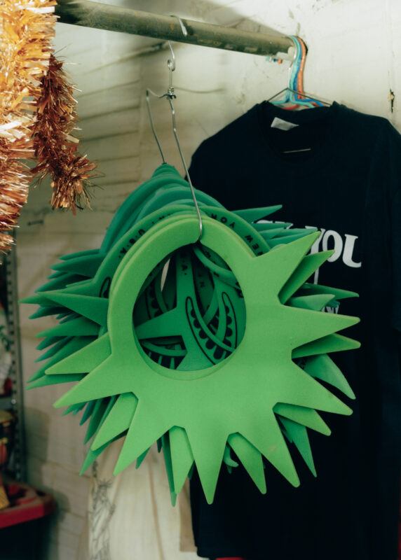 A hanger full of foam Statue of Liberty headpieces hanging on a clothing rack.