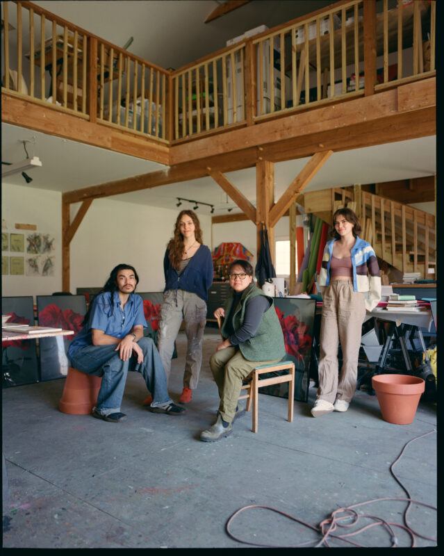 Tammy Nguyen and three studio team members arranged in the center of her studio.